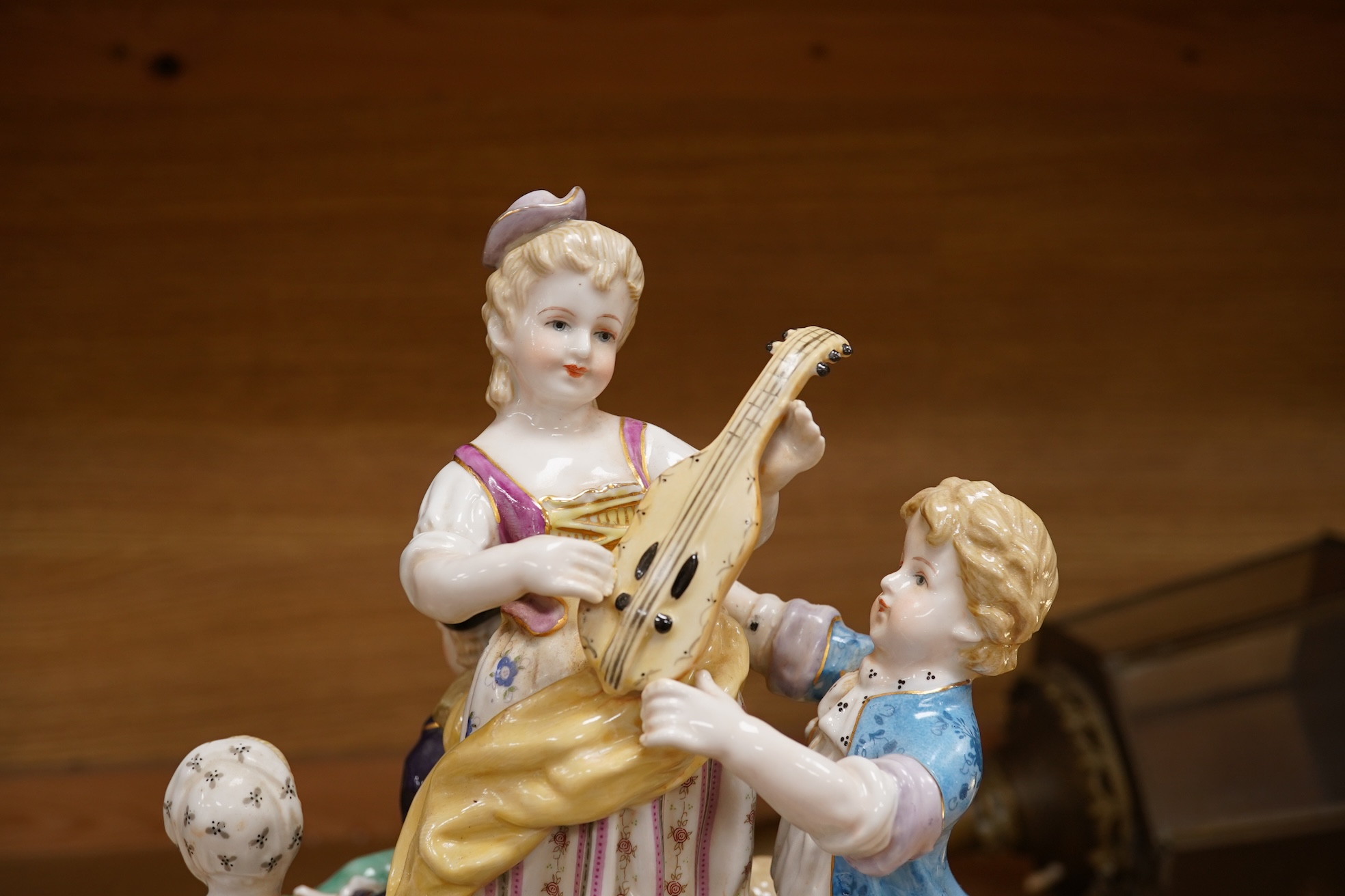 A large German porcelain group, figures playing instruments, 35cm high